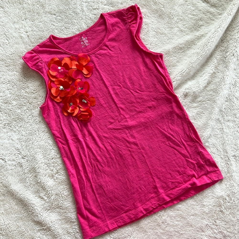 Perfect for spring girls top with flower embellishment.
